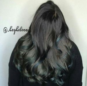 bright colored teal highlights on chocolate brown hair